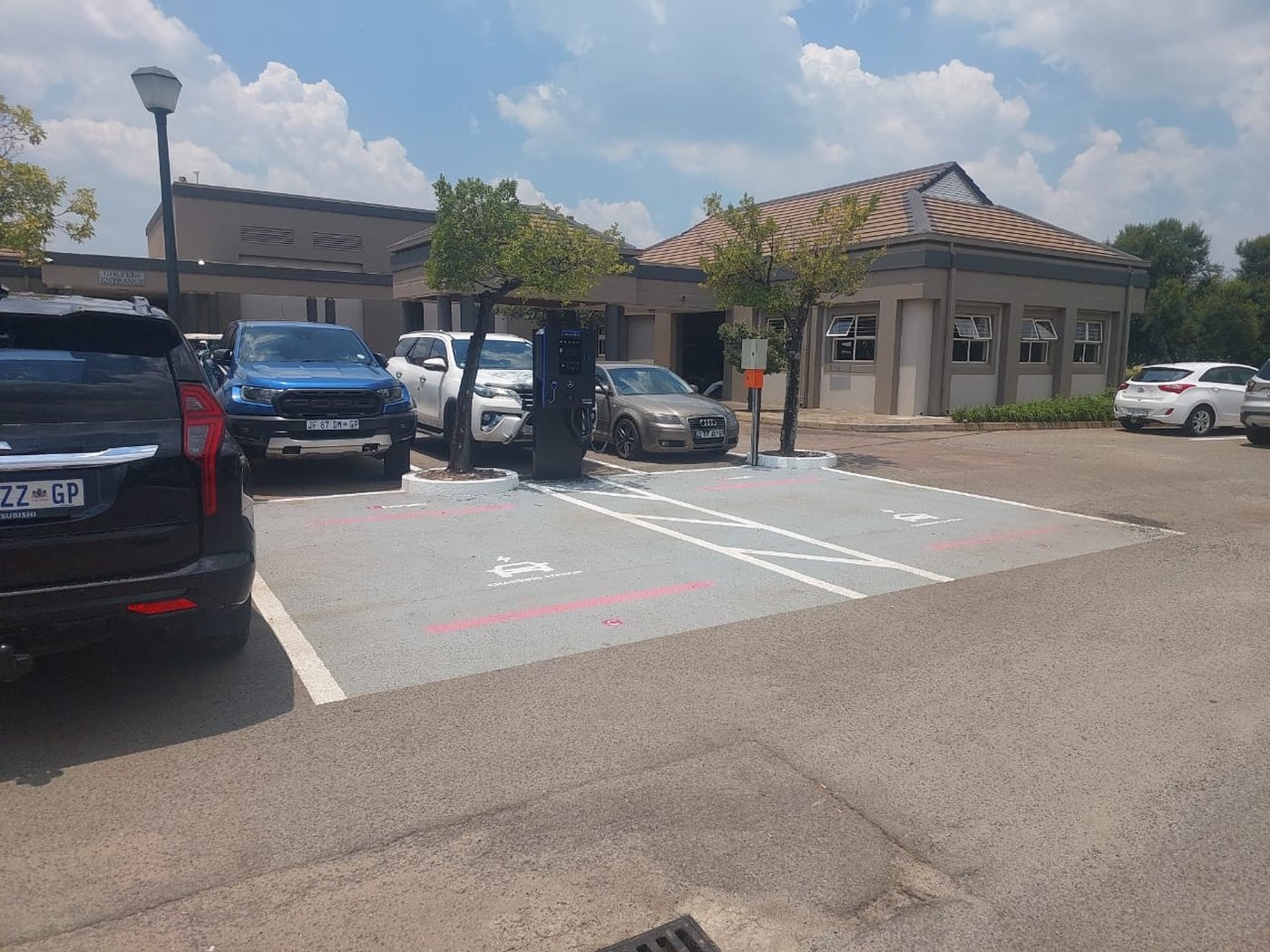 Chargify EV charging bay in a commercial parking area, daytime