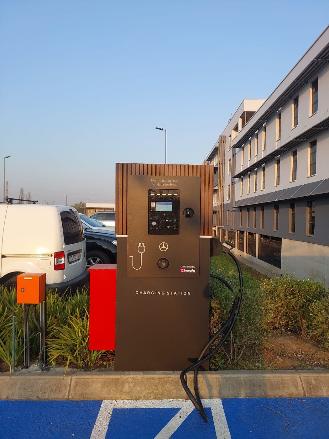 Mercedes-Benz Electric Intelligence charging station outside a dealership building