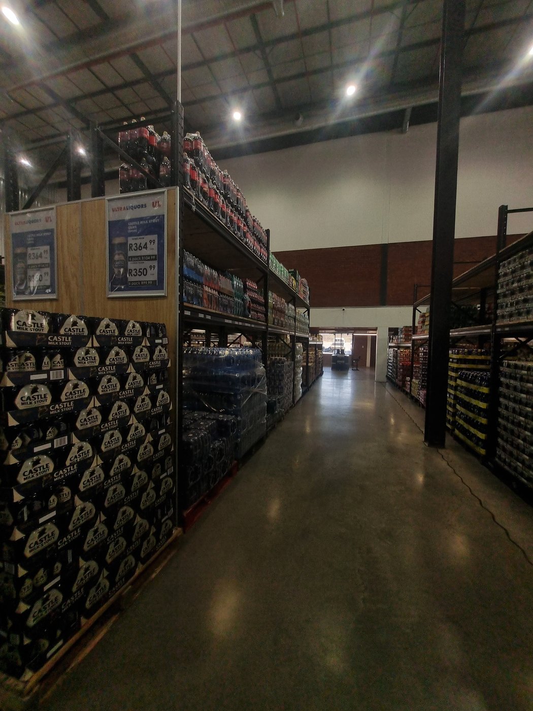 Ultra Liquors branded retail aisle with LED lighting