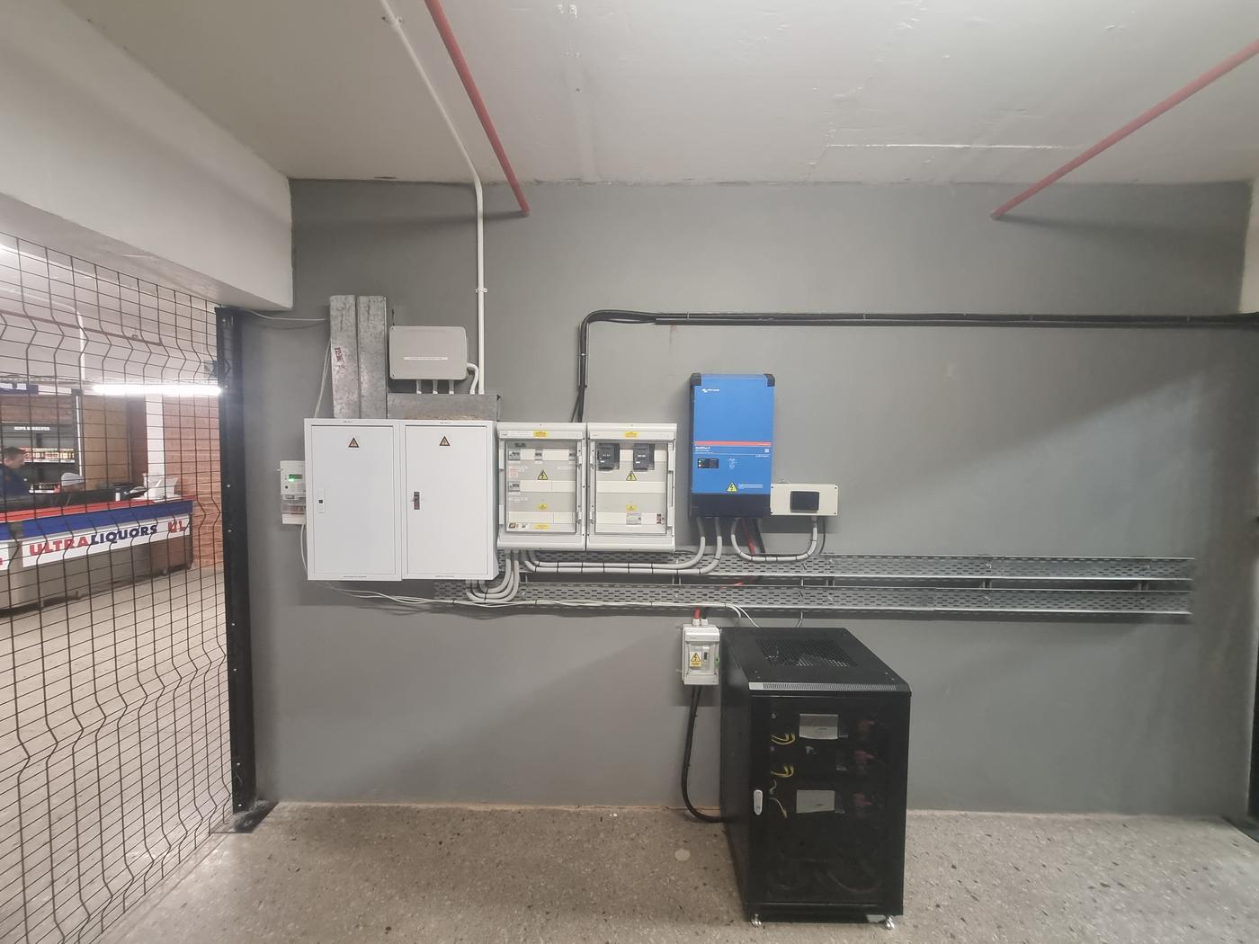 Electrical and solar plant room, with the Ultra Liquors storefront visible beyond