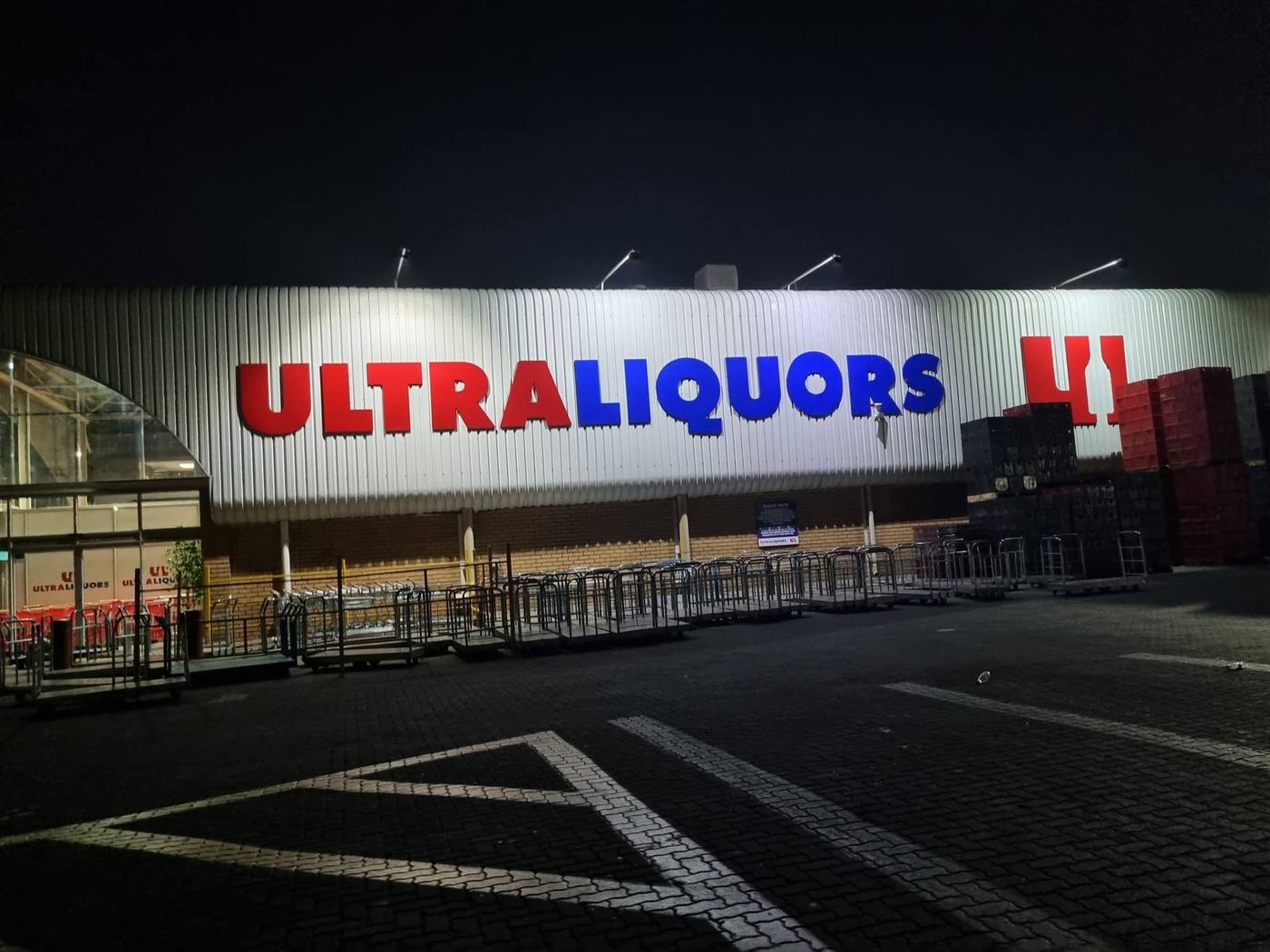 Ultra Liquors storefront lit up at night